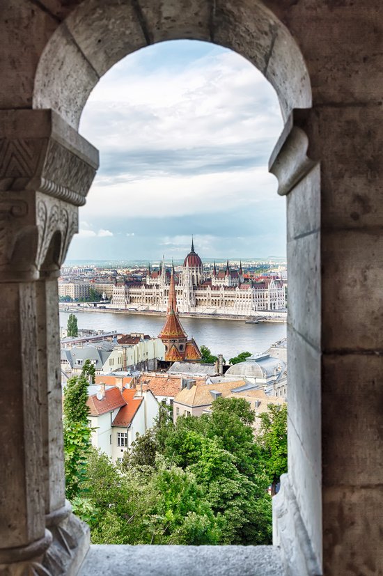 View from a window of the Fishermans Bastion of the Hungarian Parliament in Budapest on the opposite bank of the Danube.